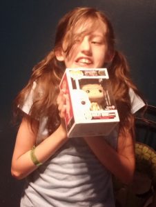 Harley with a Funko POP of her namesake, age 10